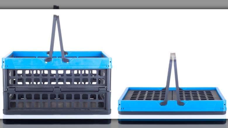 black and blue collapsible shopping basket on a white background