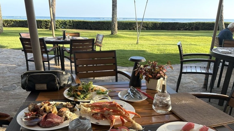 Table at Plumeria Beach House with food on table and view of ocean