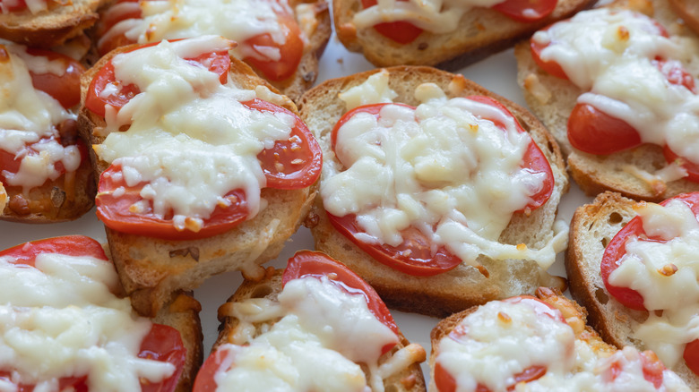 Melted mozzarella cheese and tomatoes on toasted bread