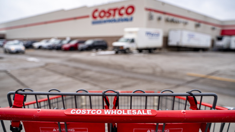 Exterior of a Costco, daytime, with shopping cart in foreground