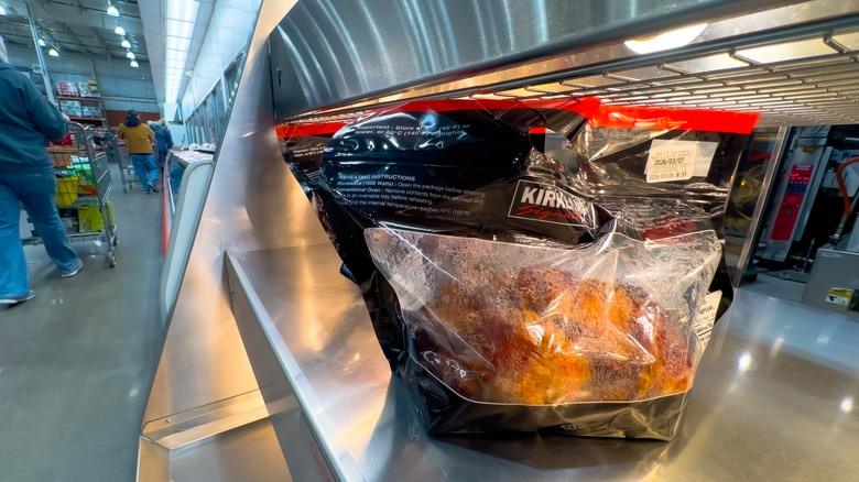Kirkland rotisserie chickens on a heated store shelf