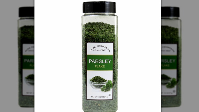 Olde Thompson parsley flakes on a white background, mirrored