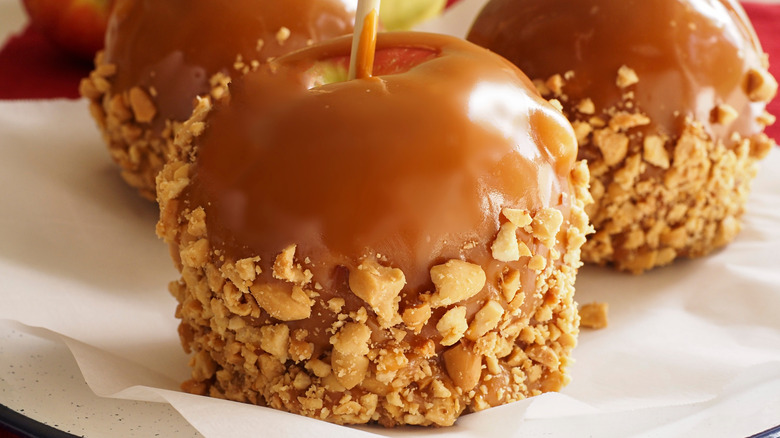 A close-up of a caramel apple on a stick