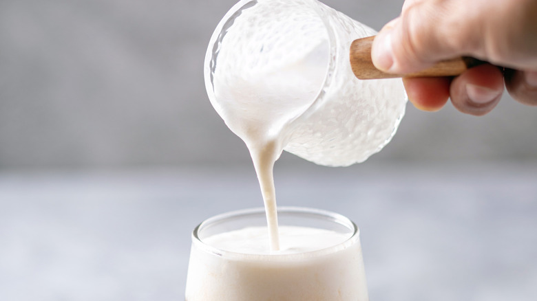 Close-up of cream being poured into a dirty soda