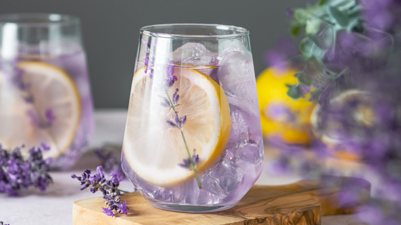 A lavender lemon drink in a glass