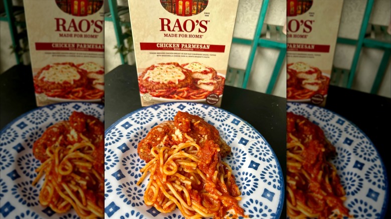 Box of Rao's chicken parmesan with spaghetti frozen dinnner next to plate of the spaghetti