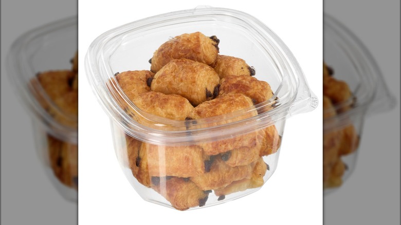 A plastic box full of the Kirkland Signature Mini Pains Au Chocolat sold at Costco.