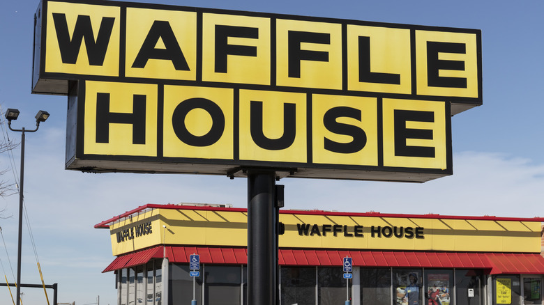 Waffle House sign against blue sky