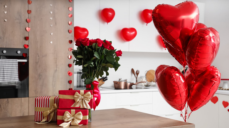 Valentine's Day gifts, flowers, and balloons in a kitchen