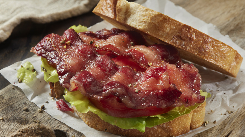 Glistening bacon slices on a BLT sandwich