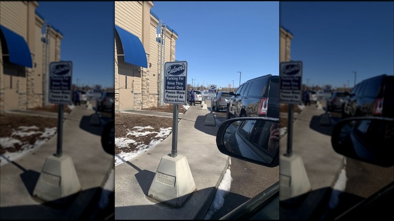 A sign at a drive-thru line at Culver's, mirror