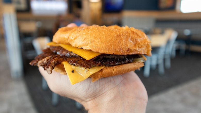 A hand holding a ButterBurger from Culver's