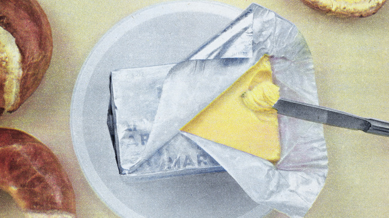 An old ad for Kraft margarine with a foil package of margarine sitting on a white plate