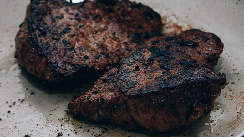 Burned steak in a frying pan