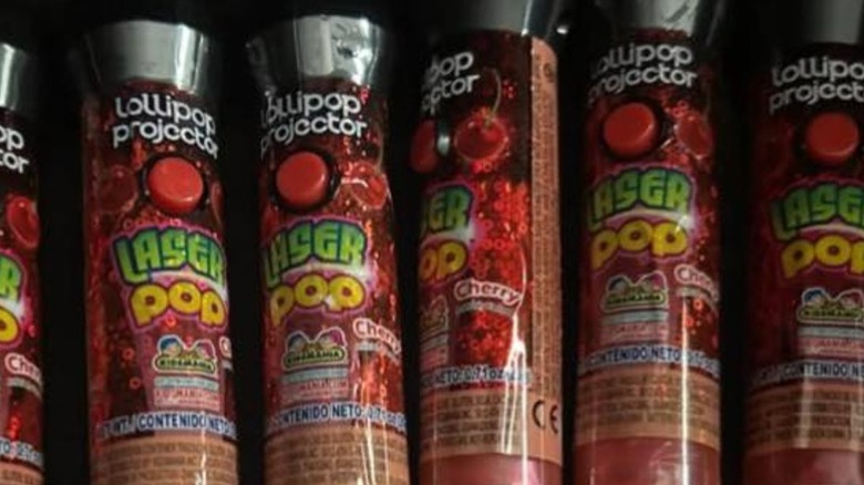 Six cherry-flavored Laser Pop Lollipop Projectors in a row.
