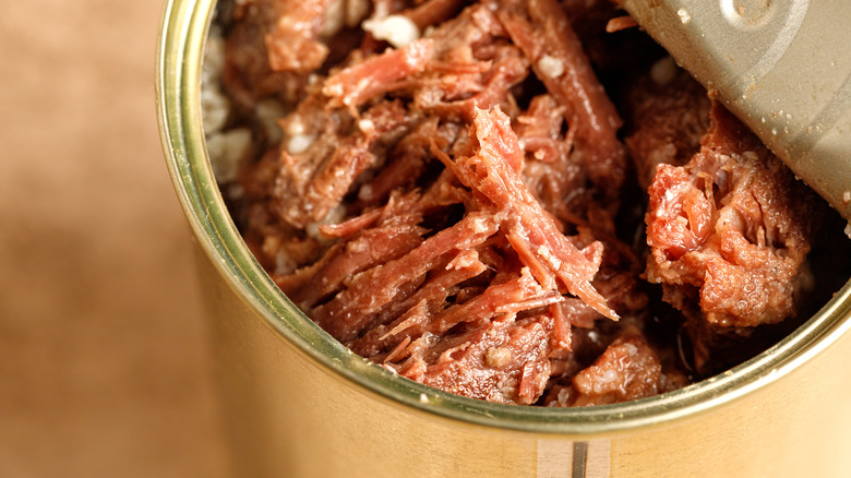 metal jar open and revealing shredded meat