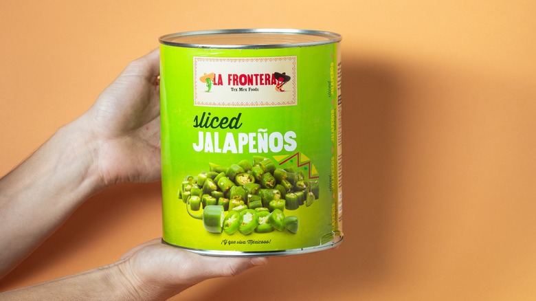 hand holds large can of sliced jalapenos