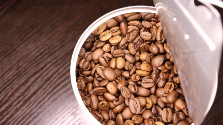open can of coffee beans on wooden table