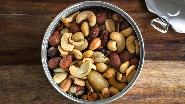 open can of nuts on wood table