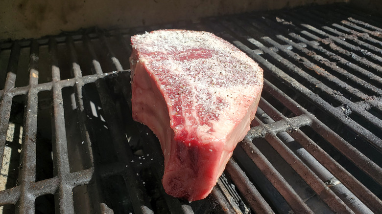 Frozen steak on cold grill