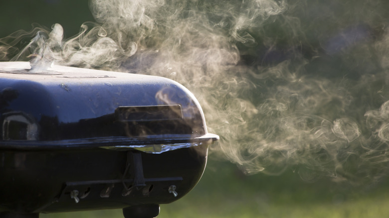 Closed grill with smoke drifting off