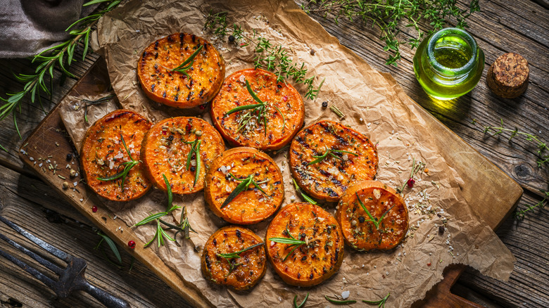 Grilled sweet potato slices on a cutting board