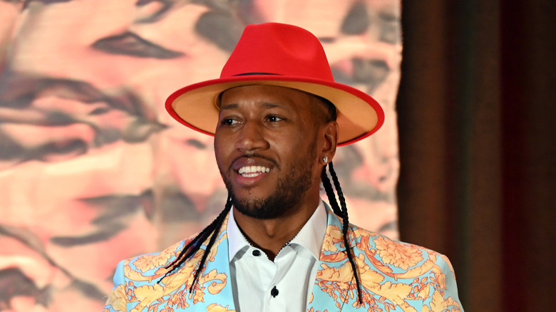 Darnell Ferguson wearing a red brimmed hat