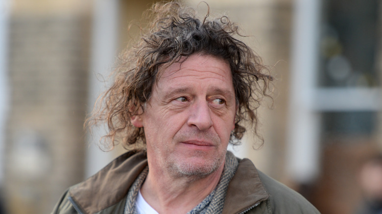 Marco Pierre White looks over his left shoulder