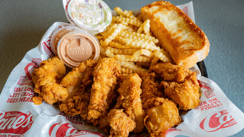Raising Cane's chicken finger meal with fries, toast, coleslaw, and sauces