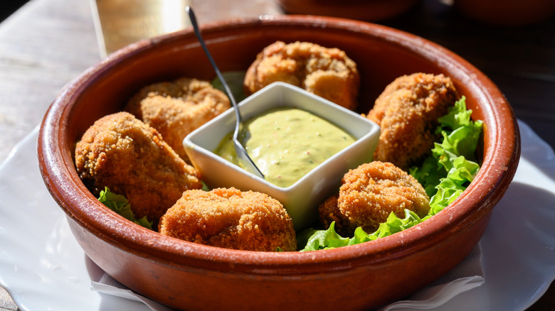 Fried whole mushrooms with bread crumbs served with a dipping sauce