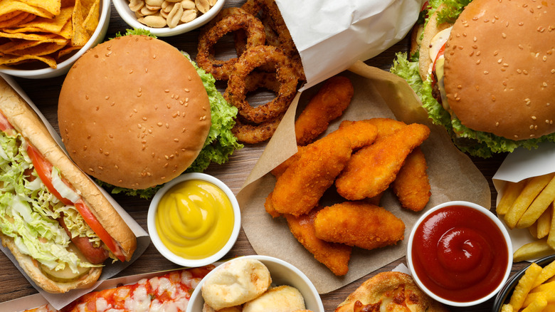 French fries, burgers, onion rings, chips, chicken dippers, and other fast food with dips