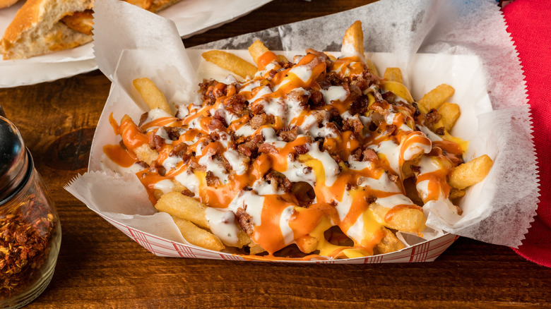 Loaded fries with bacon, ranch, and buffalo sauce