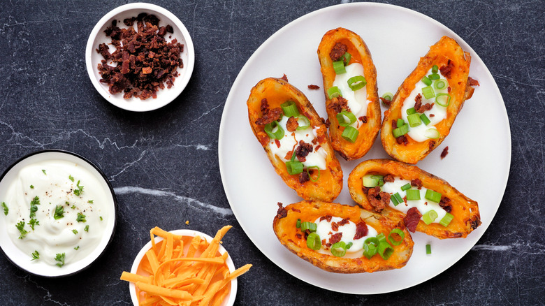 Loaded potato skins with cheese, sour cream, bacon, and onions