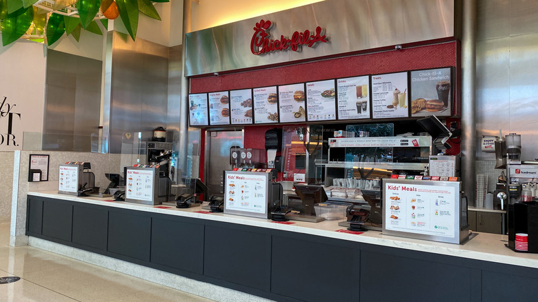 Inside a Chick-fil-A restaurant with kids meal menus on display