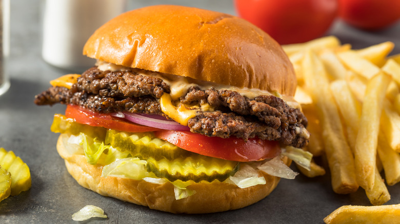 Close up of a burger with two patties and fries