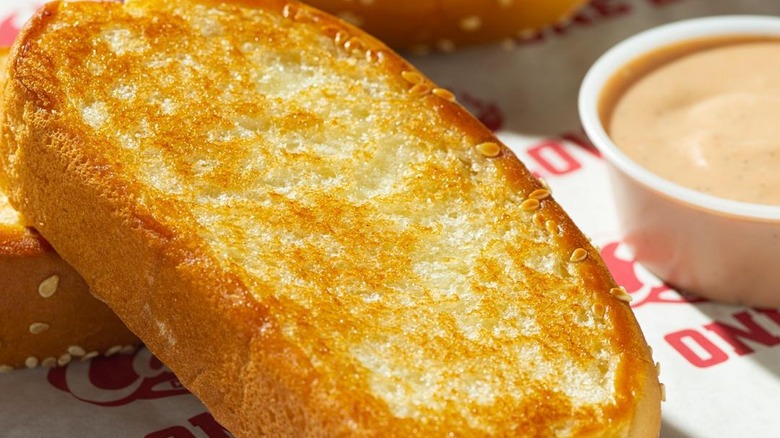 Close of of Raising Canes BOB Texas Toast with Cane's next to it