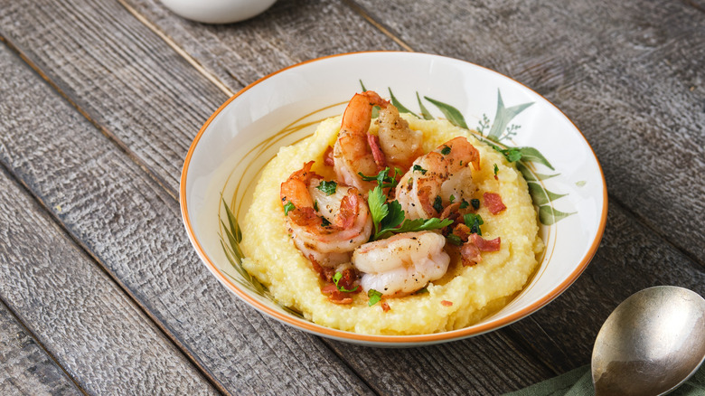 Garnished shrimp and grits with spoon