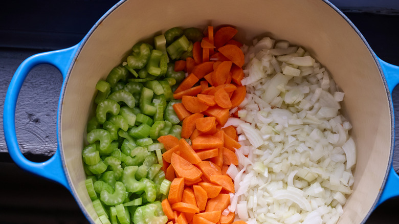 Diced celery, carrots, and onions in pot