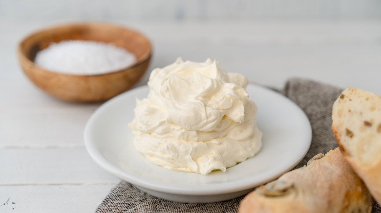 Plate of whipped butter with bread and salt