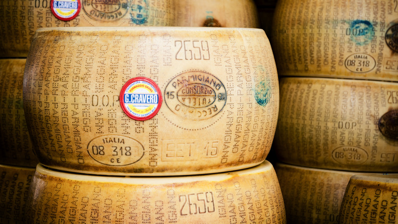Several wheels of Parmesan cheese stacked on top of each other.