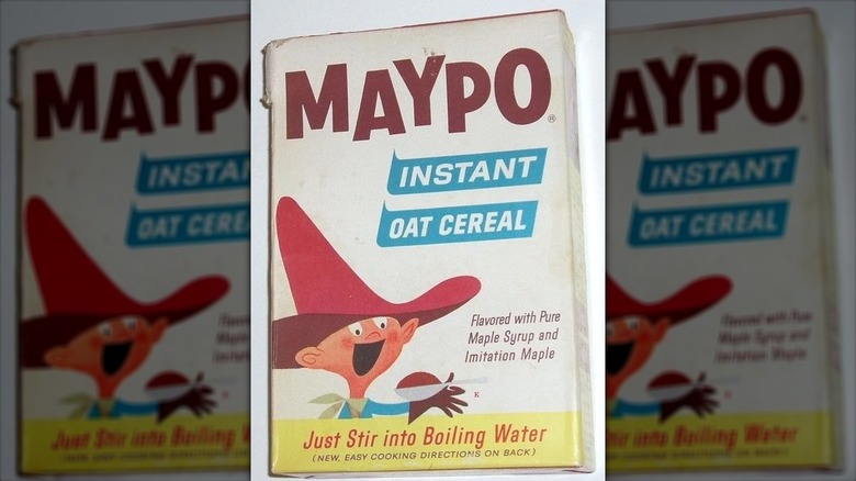 A vintage box of Maypo Instant Oat Cereal; "Maypo" is on top in brown; cartoon-drawn excited-looking boy with a tall red cowboy hat on the left  about to eat a spoonful of food