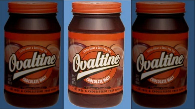 A jar of chocolate malt-flavored Ovaltine; brown with an orange cap and label; "Ovaltine" logo is in white cursive letters
