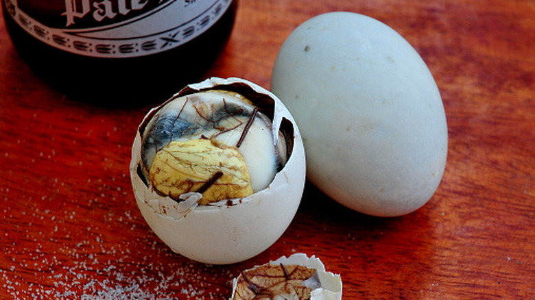 Balut egg cracked open at the top