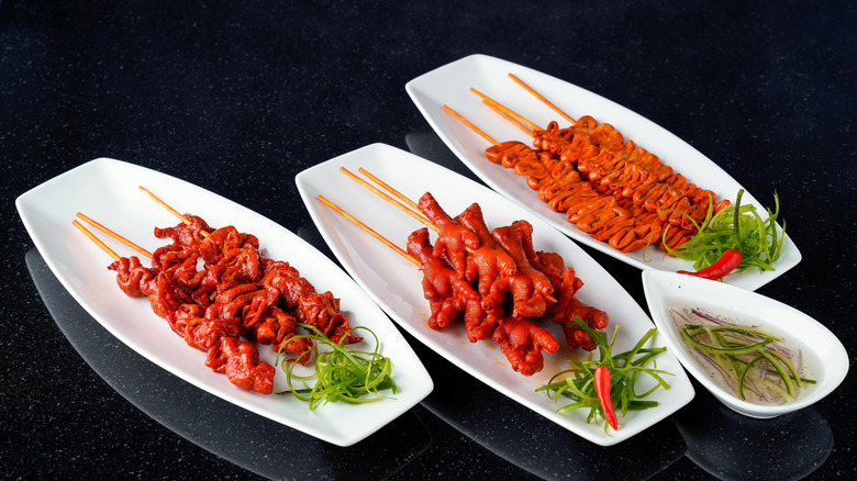 Skewers of isaw on plates