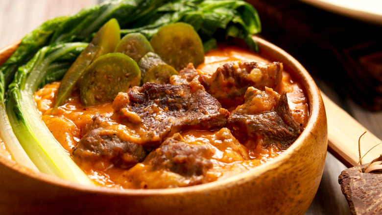Bowl of kare-kare served with vegetables