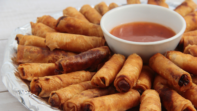 Plate of lumpia with sauce in the middle