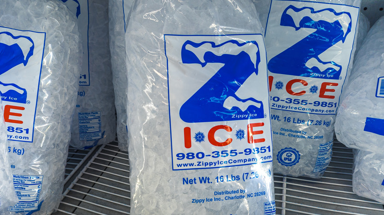 Multiple bags of ice on a wire shelf