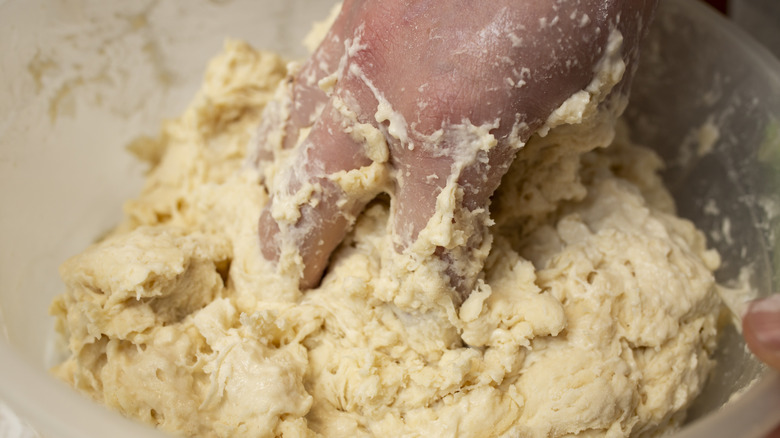 Person mixing raw dough