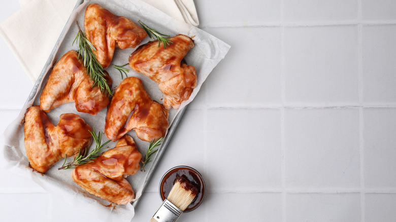 Chicken wings in marinade on a tray
