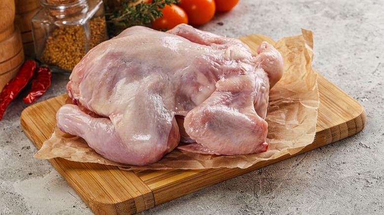 Raw chicken on a wooden cutting board